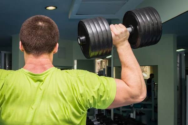 Man doing exercises with dumbbell — Stock Photo, Image