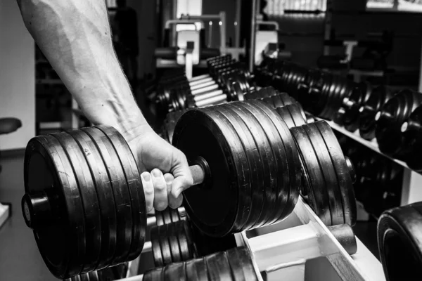 Uomo che fa esercizi con manubri in palestra — Foto Stock