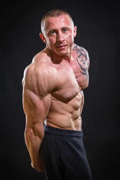 Muscle man with tattoos — Stock Photo, Image