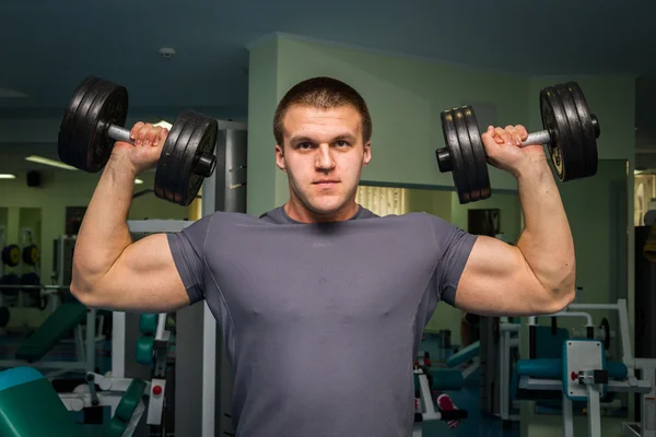 Man exercising with dumbbells Stock Picture