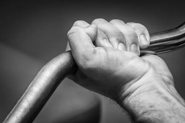 Hand holding barbell — Stock Photo, Image