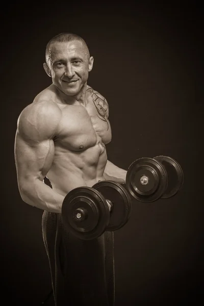 Bodybuilder with dumbbells — Stock Photo, Image