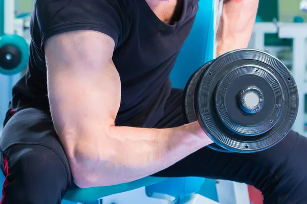 Man doing workout with heavy dumbbell — Stock Photo, Image