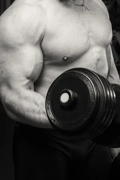 Man doing workout with heavy dumbbell — Stock Photo, Image