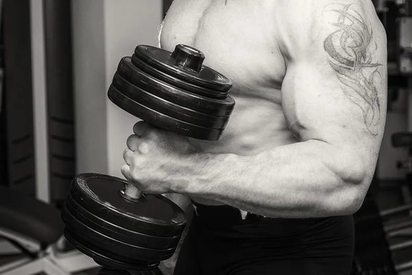 Man doing workout with heavy dumbbell — Stock Photo, Image