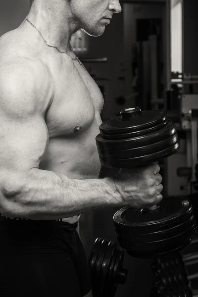 Man doing workout with heavy dumbbell — Stock Photo, Image