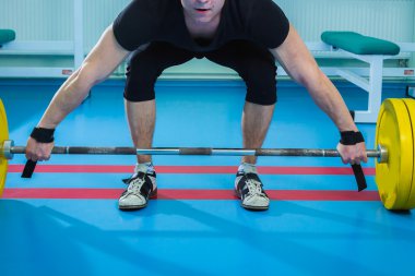 Genç kaslı adam ağırlık kaldırma