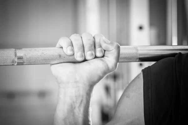 Hand holding barbell — Stock Photo, Image