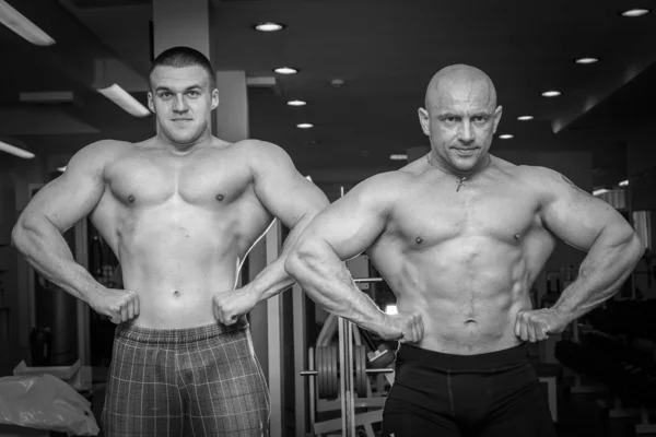 Två bodybuilders visar musklerna — Stockfoto