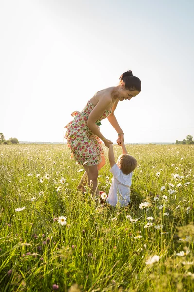 Mom and son playing in a field — Stock Photo, Image