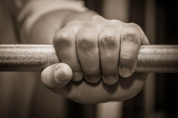 Hand holding barbell — Stock Photo, Image