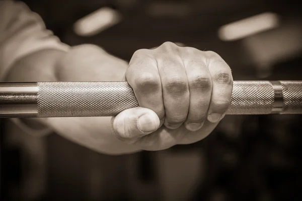 Hand holding barbell — Stock Photo, Image