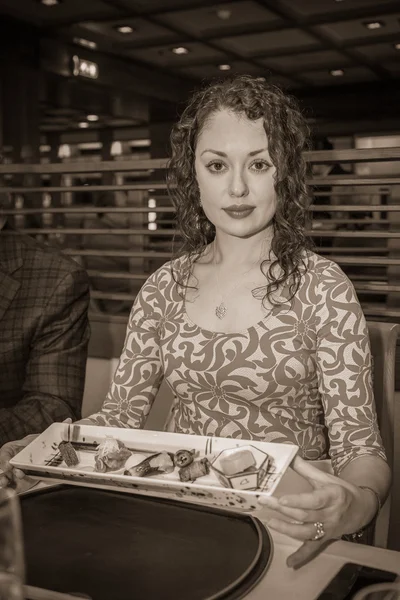 Žena sedí a drží potravin — Stock fotografie