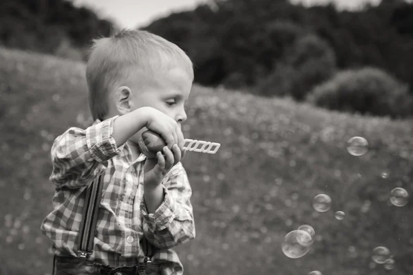 Boy inflating soap bubbles — Stock Photo, Image