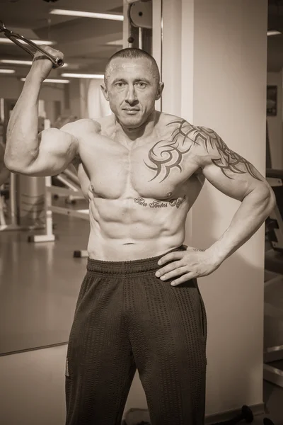 Man with tattoo in the gym — Stock Photo, Image