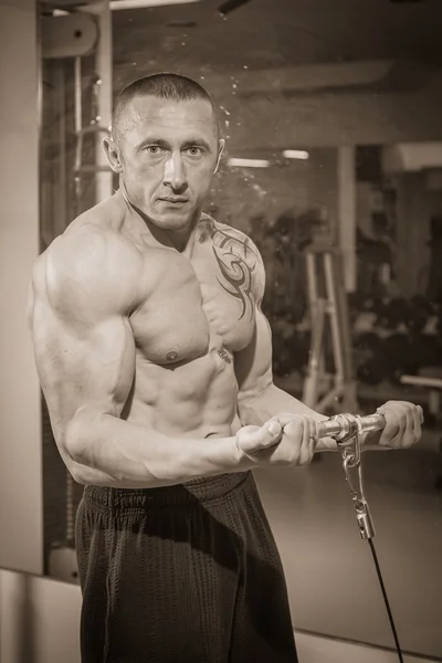 Man with tattoo in the gym — Stock Photo, Image