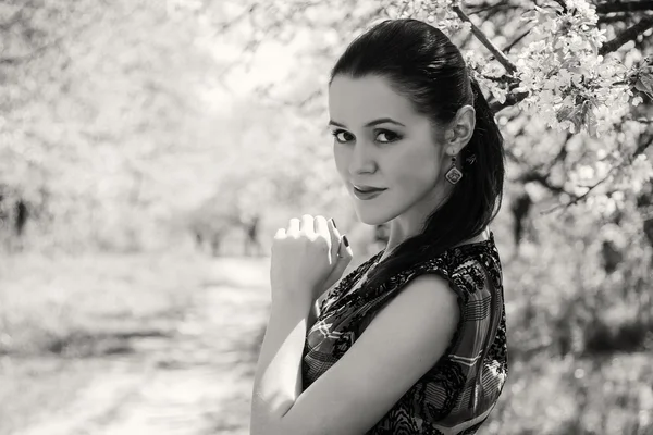 Girl near a flowering tree — Stock Photo, Image