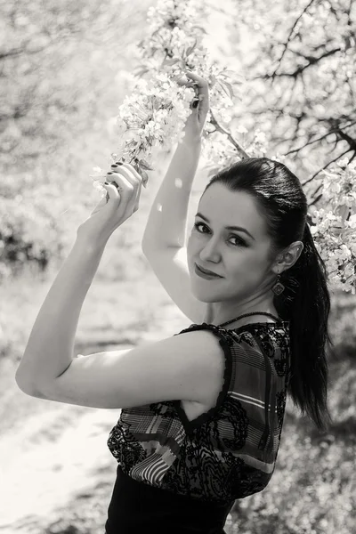 Girl near a flowering tree — Stock Photo, Image