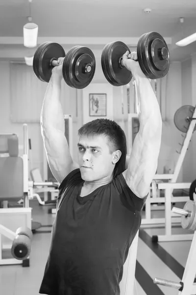 Man doing workout with heavy dumbbell — Stock Photo, Image