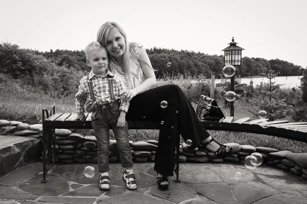 Mother with son near the source of water — Stock Photo, Image