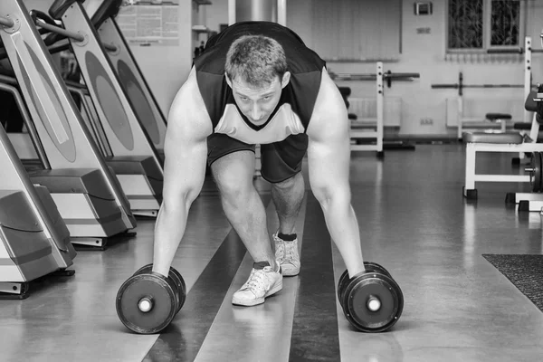 Man doing workout with heavy dumbbell — Stock Photo, Image