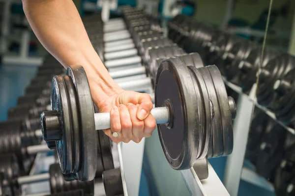 Womans hand holding dumbbell — Stock Photo, Image