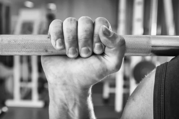 Strong hand holding barbell — Stock Photo, Image