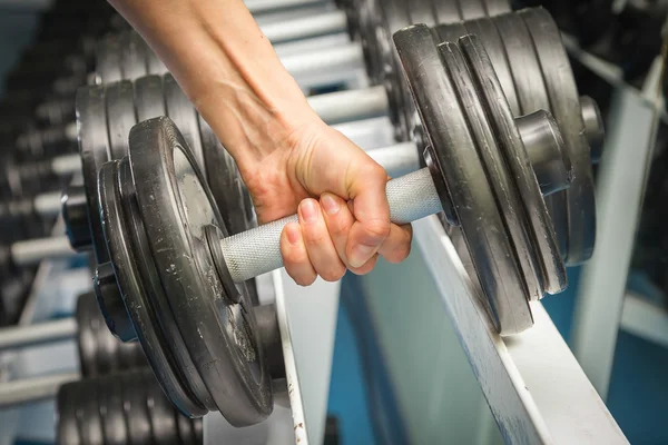 Womans hand holding dumbbell — Stock Photo, Image