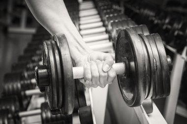 el bir dumbbell tutarak.