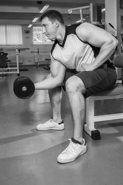 Man makes exercises with dumbbells. — Stock Photo, Image