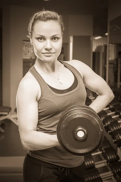 Woman holding dumbbell — Stock Photo, Image