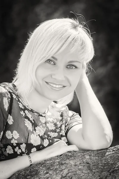 Blonde in dress in garden — Stock Photo, Image