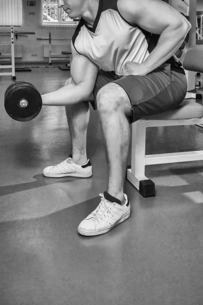 Man makes exercises with dumbbells. — Stock Photo, Image