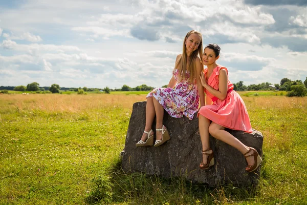 Girls sitting on stone — Stock Photo, Image