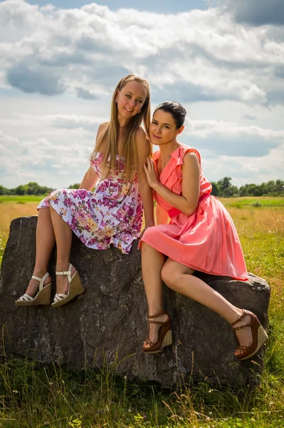 Girls sitting on stone — Stock Photo, Image