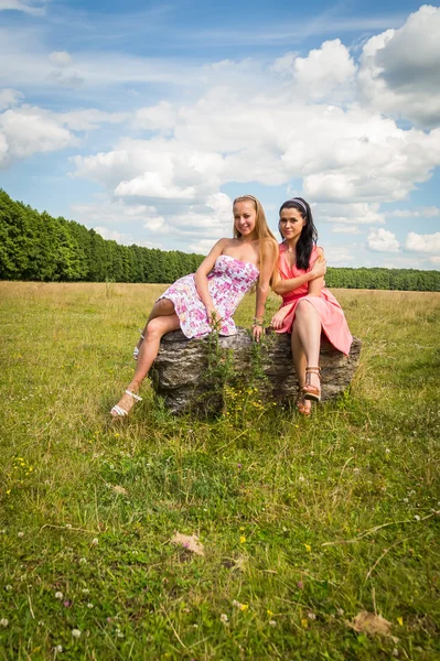 Girls sitting on stone — Stock Photo, Image