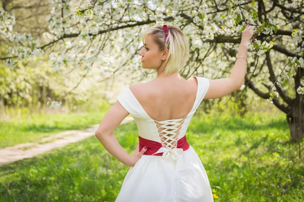 Blonde in the spring garden — Stock Photo, Image