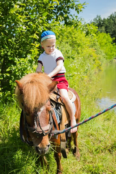 Boy riding pony — Stock Photo, Image