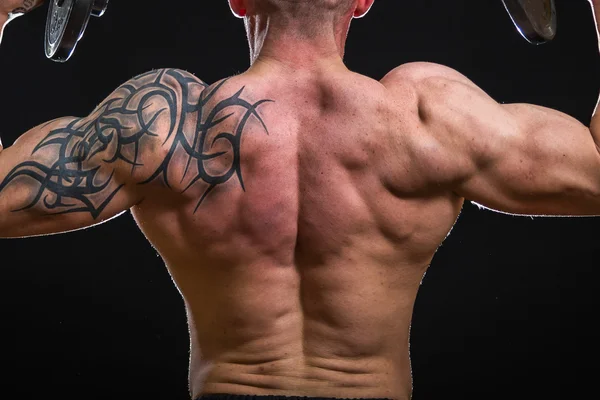 Muscle man with dumbbells — Stock Photo, Image