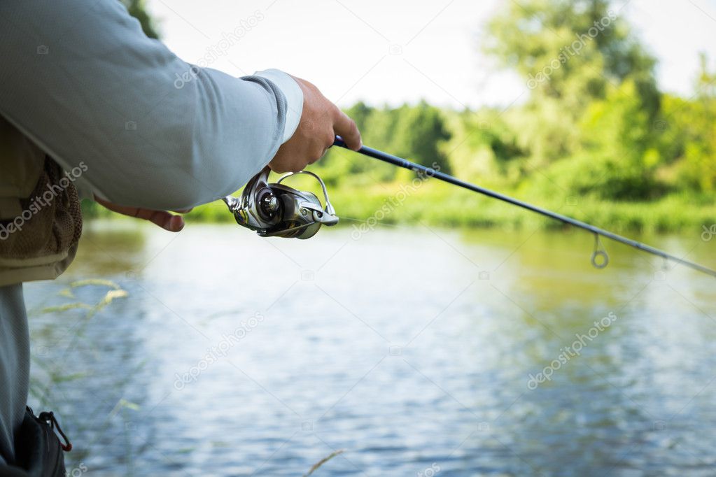 Fisherman holding spinning