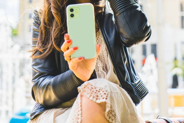 Woman with cell phone on the street