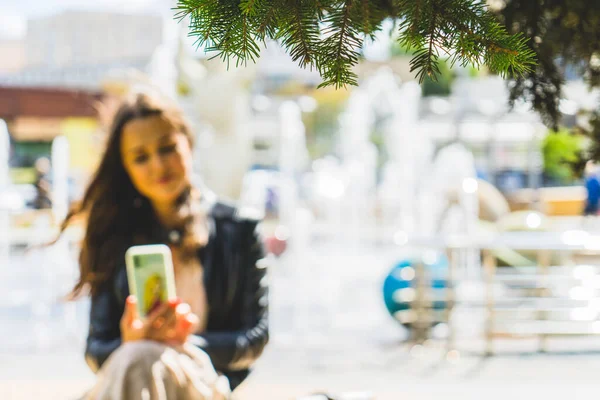 Woman with cell phone on the street