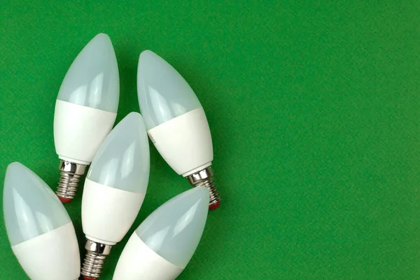 Many of LED light bulbs, energy saving and eco friendly concept. Green background, flat lay, top view and copy space
