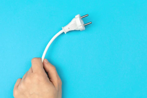 Hand Holding Power Cable Plug Bright Blue Background Flat Lay — Stock Photo, Image