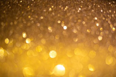 Altın gibi bir arka plan. Noel ışıltısı, desenli ve parlak ışıklı fotoğraf.