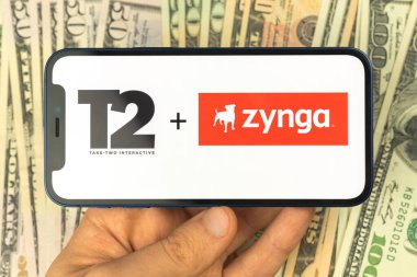 Kharkov, Ukraine - January 12, 2022: Take-Two buy Zynga, logos on the screen. Business background 
