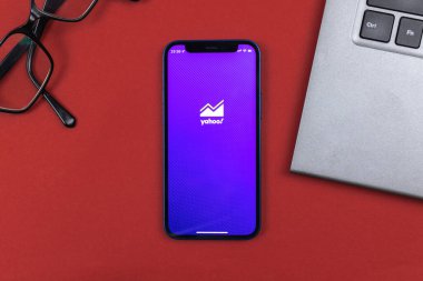 Kharkov, Ukraine - January 10, 2022: Yahoo Finance application logo. Business desktop background, top view 