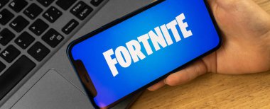 Kharkov, Ukraine - January 14, 2022: Apple iPhone with Fortnite logo, banner, closeup