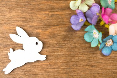 Happy easter concept, colorful spring holiday flower decorations, old rustic wood background. Flat lay design, top view with copy space 