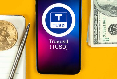 TrueUSD TUSD madeni para sembolü. Şifreli para ticareti, dijital ve sanal para, cep telefonu konsepti ile bankacılık. Çalışma alanı, masa üstü fotoğrafı.